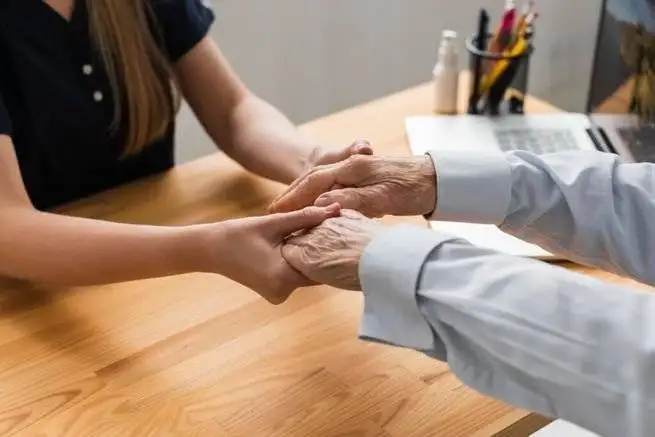 nurse holding senior man s hands 1024x683 1